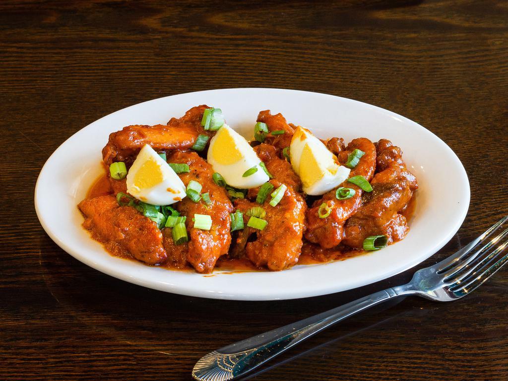 Chicken 555 · Boneless chicken pieces made with a variety of South Indian spices, topped with boiled eggs.