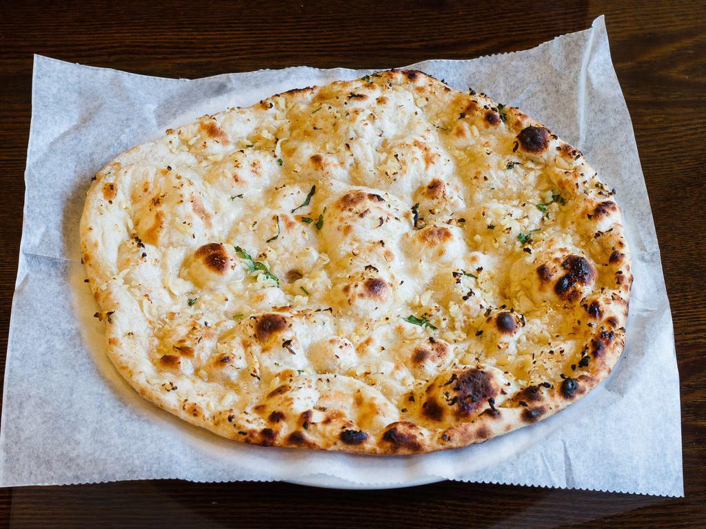 Garlic Naan · Fresh dough topped with chopped garlic and baked in tandoor oven.