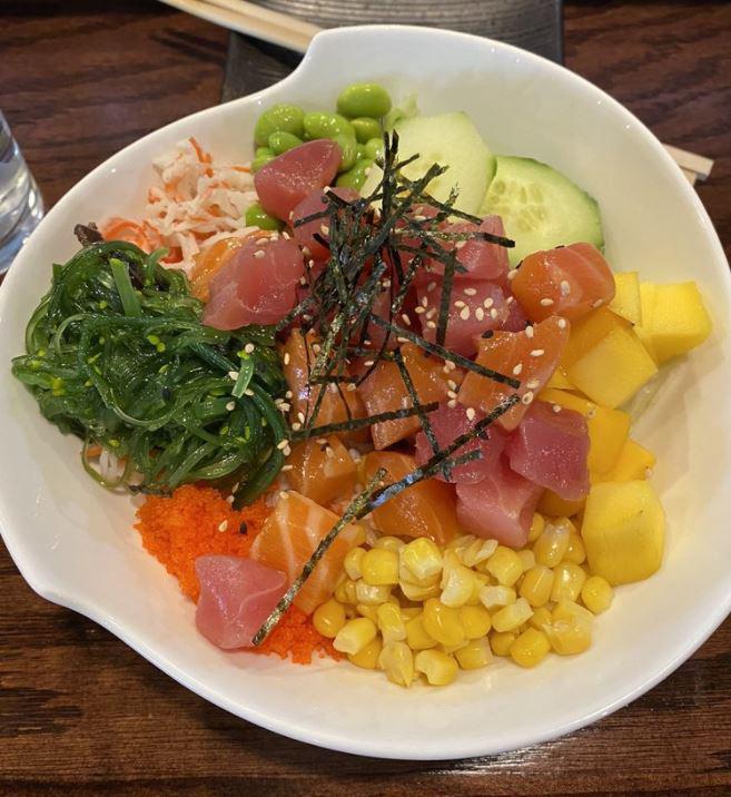 Poke Signature · Tuna.salmon. Crab, cucumber, edamame, mango, corn, masago, seaweed salad white rice,green salad, topped with house sauce.
