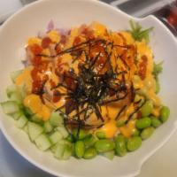 Passion Salmon Poke Bowl · Spicy salmon, cucumber, red onion, edamame, masago, seaweed salad, white rice, topped with s...