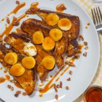 Banana Nut French Toast · buttery slices of brioche in batter, griddled, topped with pecans, banana, caramel