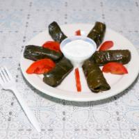 Dolmades · Stuffed grape leaves with rice.