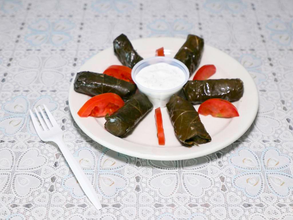 Dolmades · Stuffed grape leaves with rice.
