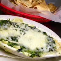 Spinach and Artichoke Dip · Served with chips.