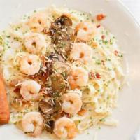 Shrimp Alfredo Pasta · Pasta and creamy Alfredo sauce topped with mushrooms and bacon bits.