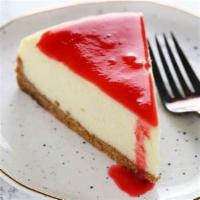 Cheesecake · Served with strawberry or raspberry topping and whipped cream.