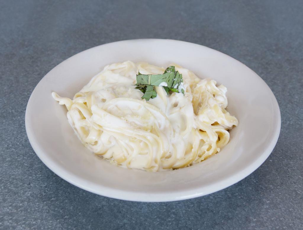 Fettuccine Alfredo · Served with small house salad.