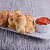 Garlic Knots · Our signature Oggi's dough tied off and baked to a golden brown. Tossed in our garlic butter...
