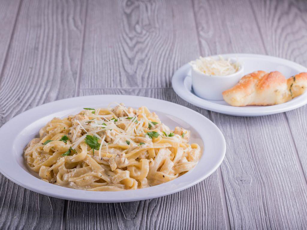Chicken Alfredo · Classic Alfredo sauce with a blend of garlic, cream and cheeses served over fettuccine topped with all-natural grilled chicken. Served with an Oggi's garlic knot.