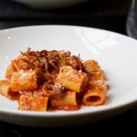 Rigatoni Amatriciana · Housemade rigatoni pasta with traditional onion, guanciale and tomato 