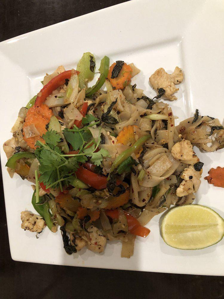 Drunken Noodles · Stir fried wide rice noodle, green and red bell peppers, white and green onions, celery, carrots and basil leaves. Served with lime, cilantro and your choice of protein.