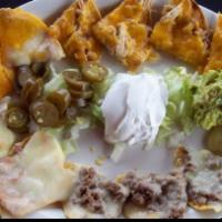 Chicken & Cheese Nachos  · Chips with cheese and a variety of toppings. Served with sour cream.