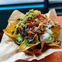 Ground Beef Nachos  · Chips with cheese and a variety of toppings. Served with guacamole.