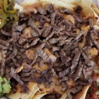 Nachos Libre · Tortilla chips smothered in beans and cheese with choice of meat. Includes guacamole, sour c...