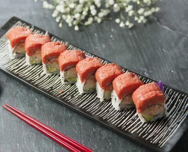 Hama Roll · Spicy snow crab, avocado, cucumber, top with spicy tuna. 