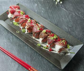 Dancing Tuna Roll · Spicy tuna crunch, topped with avocado blackened tuna. 