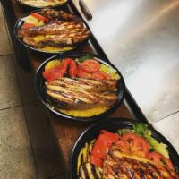 Grilled Salmon · Served with rice, mix vegetables, side salad and pita bread.