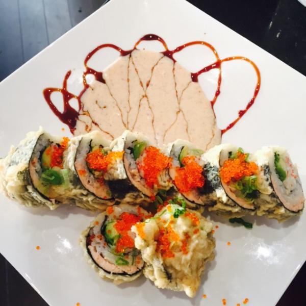 A's Roll · Deep Fried roll. Crab meat and avocado topped with salmon,  tobiko. chef special sauce on the side