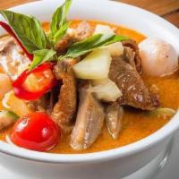 Duck curry · Red curry with coconut milk, pineapples, tomatoes, bell pepper, and basil leaves. 