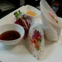 Superman Burrito · Tuna, salmon, yellowtail, crab meat, and avocado inside wrapped with soy paper, served with ...