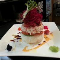 Sake Tower · Salmon, spicy tuna, crab meat, avocado, rice, masago, radish sprout built in tower, served w...