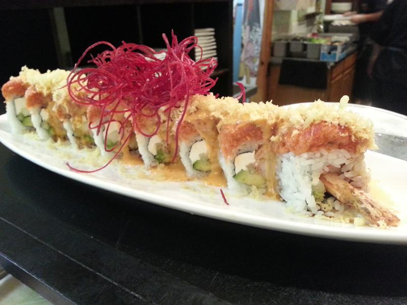 Hot Night Roll · Shrimp tempura, avocado, cucumber, cream cheese, and crab stick inside topped with spicy tuna and tempura flakes, served with house special sauce. Raw. Spicy.