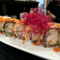 Lion King Roll · Shrimp tempura, crab meat, avocado, inside topped with salmon, eel, and masago, served with ...