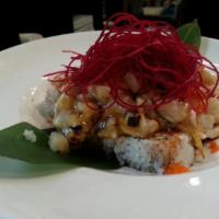Magma Roll · California roll topped with baked creamy scallop, krab and masago served with Midori sauce.