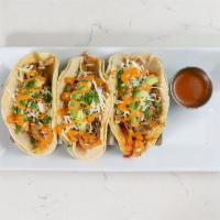 Hand-Pulled Chicken Tacos (GF) · roasted all-natural zaatar-crusted chicken topped with sautéed red onions, yellow & red bell...