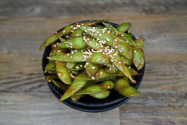 Spicy Miso Soybeans · Steamed soybeans tossed in miso and Hawaiian chili peppers, topped with roasted sesame seeds.