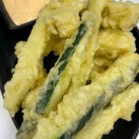 Zucchini Fries · Local zucchini deep fried in our crispy tempura batter served with our house made carrot aio...