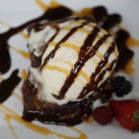 Brownie a Ia Mode · Freshly baked warm fudge brownie served with vanilla ice cream, caramel drizzle a hazel nut ...