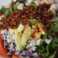 Cobb Salad · Baby greens, grilled chicken, bacon, bleu cheese, tomato, capers and red onion.