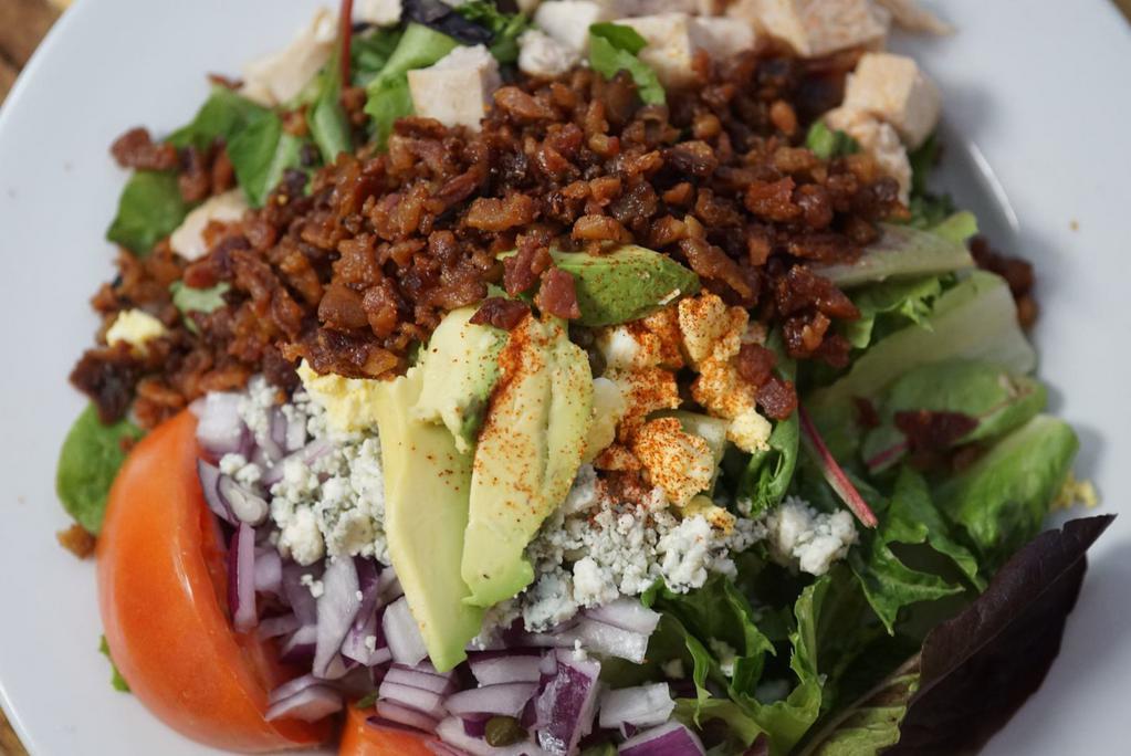 Cobb Salad · Baby greens, grilled chicken, bacon, bleu cheese, tomato, capers and red onion.