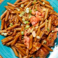 Cajun Penne · Cajun chicken or steak, tomatoes, scallions and a red wine
sauce over whole wheat pasta
