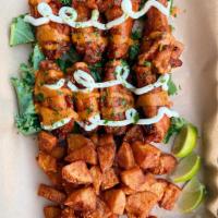 Harissa Glazed Chicken Wings · 

8 Golden crispy chicken wings tossed in a sweet harissa hot sauce, topped with spicy tahin...