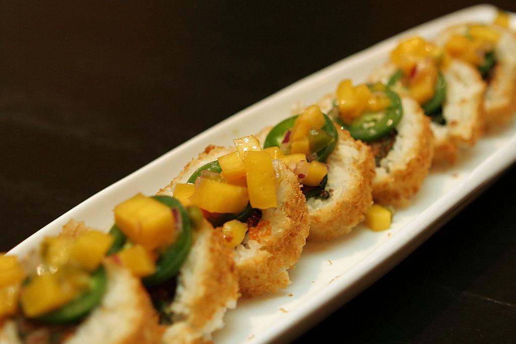 Volcano Roll · Deep fried spicy tuna topped with mango salsa, spicy mayo, spicy unagi sauce, salsa sauce with spring mix.