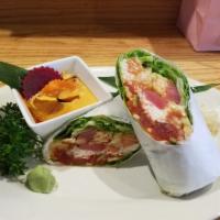 Sushi Burrito Roll · Shrimp tempura, crab, spicy tuna, seared tuna, salmon & avocado, wrapped in iceberg lettuce.