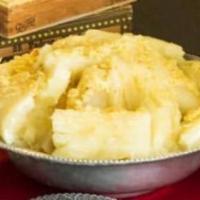Yuca con mojo · Boiled yucca topped with garlic sauce