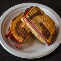 Irish Reuben Panini · Sliced pastrami, topped with melted Swiss cheese, Thousand Island dressing and sauerkraut on...