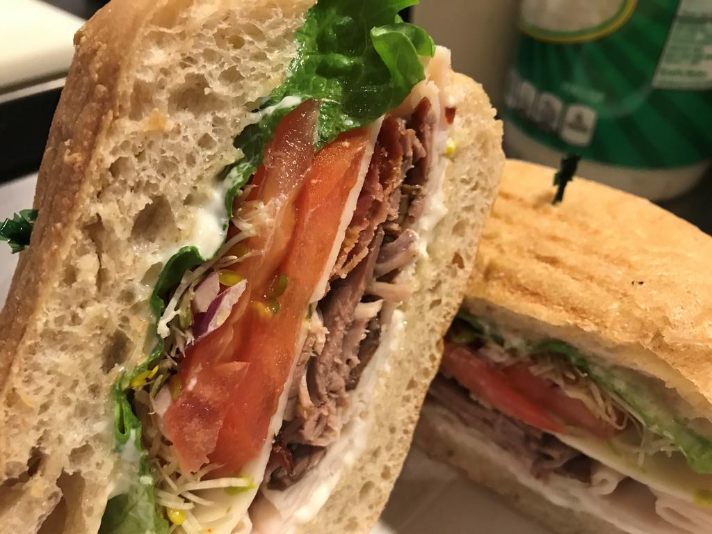 Veranda Classic · Tender roasted beef, roast turkey, bacon, Monterrey Jack cheese, lettuce, tomatoes, onions, sprouts and Dijon mustard on grilled ciabatta roll. 