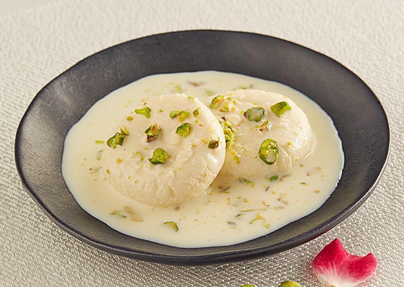 Ras Malai · Ras Malai is Indian cottage cheese dumplings in cream milk sauce, flavored with pistachios , nuts and saffron.