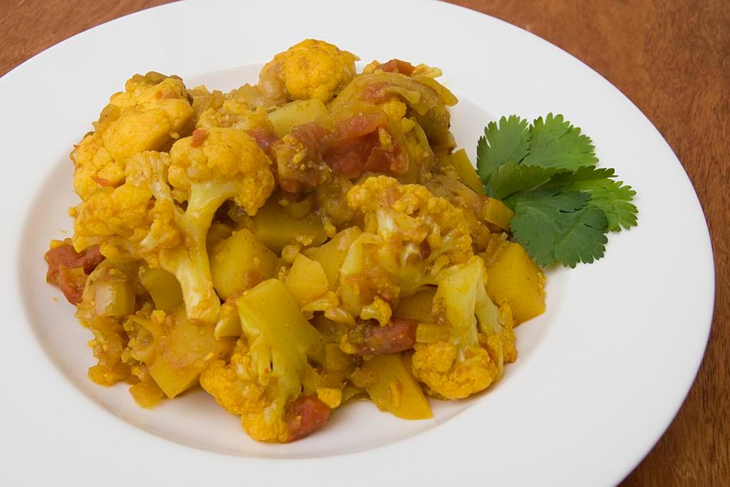 Aloo Gobi · Cauliflower and fresh potatoes cooked with onions, ginger, garlic, tomatoes and spices.