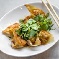 Pan Fried Pork Wontons with Hot Chili Sauce · 8 rich and tangy pork wontons pan fried golden brown and served in a spicy chili sauce (Not ...