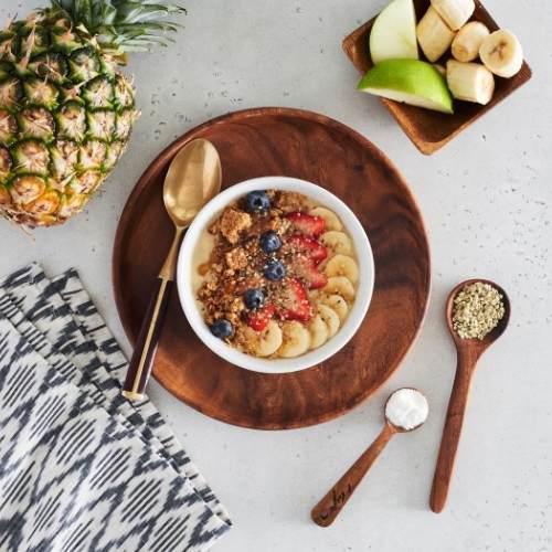Pineapple Cake Bowl · A protein packed dessert made with coconut milk, apple juice, banana, pineapple, protein powder, avocado and a hint of maca powder. Topped with granola, almond butter, strawberries, blueberries, bananas, hemp seeds and local honey.