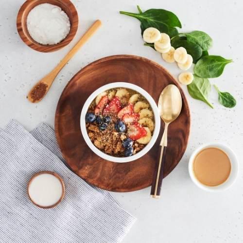 Athlete Bowl · A powerhouse blend of banana, spinach, protein powder, peanut butter, cacao powder, sea salt and almond milk. Topped with granola, almond butter, strawberries, blueberries, bananas, hemp seeds and local honey.