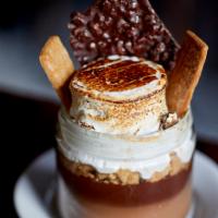 S'mores in a Jar · Chocolate pudding, graham cracker crumble, toasted marshmallow and chocolate crunch bar.