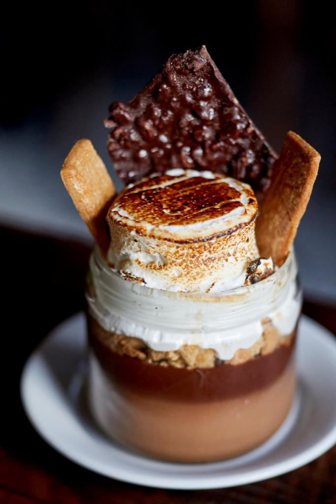 S'mores in a Jar · Chocolate pudding, graham cracker crumble, toasted marshmallow, and chocolate crunch bar.