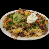Nachos Supreme · Tortilla chips served with beans your choice of meat, cheese, guacamole, sour cream, and pic...