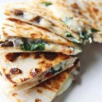 Picadillo Quesadillas · 14 inch tortilla folded and fill with quesadilla cheese and ground beef, side of rice and be...